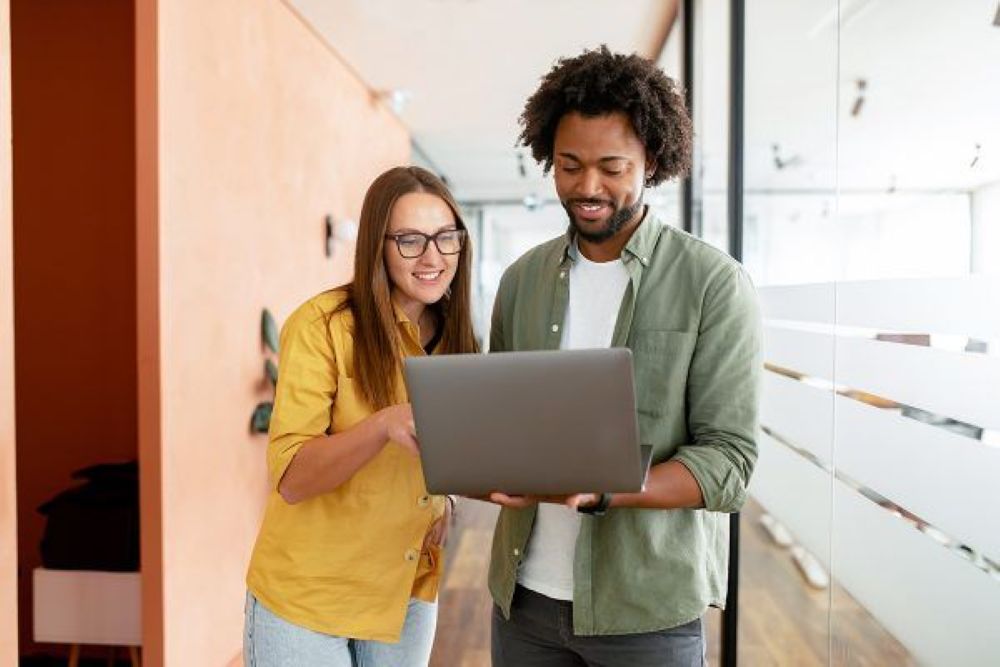 Two public Administration students sharing laptop